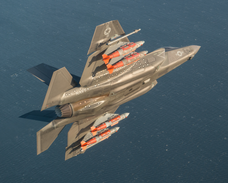 A F-35 conducts a test flight with four GBU-31 2,000 pound guided bombs and two AIM-9X Sidewinder missiles. The F-35 can carry weapons and fuel externally at the cost of its stealthy profile.